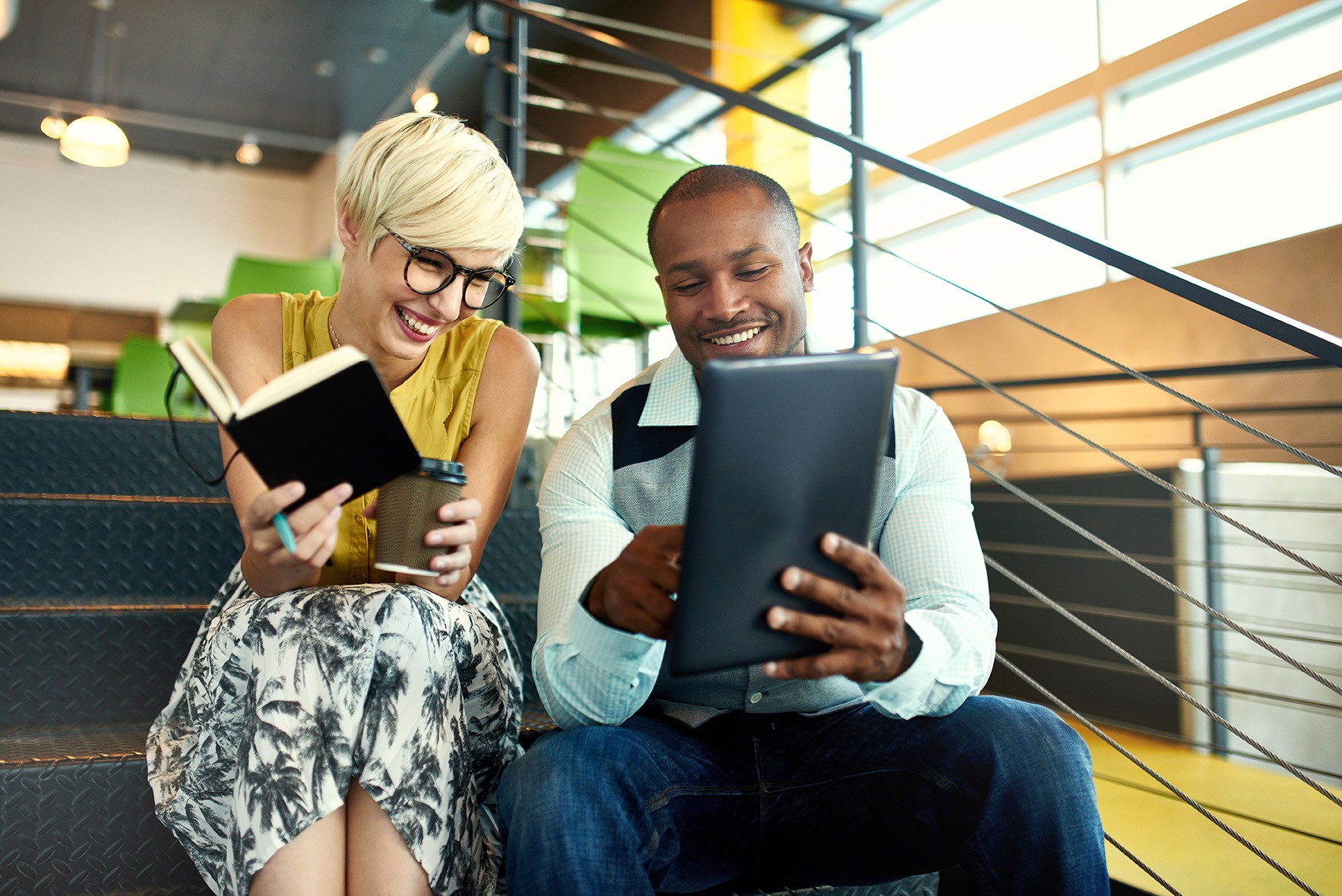 People laughing and engaging with content on a device